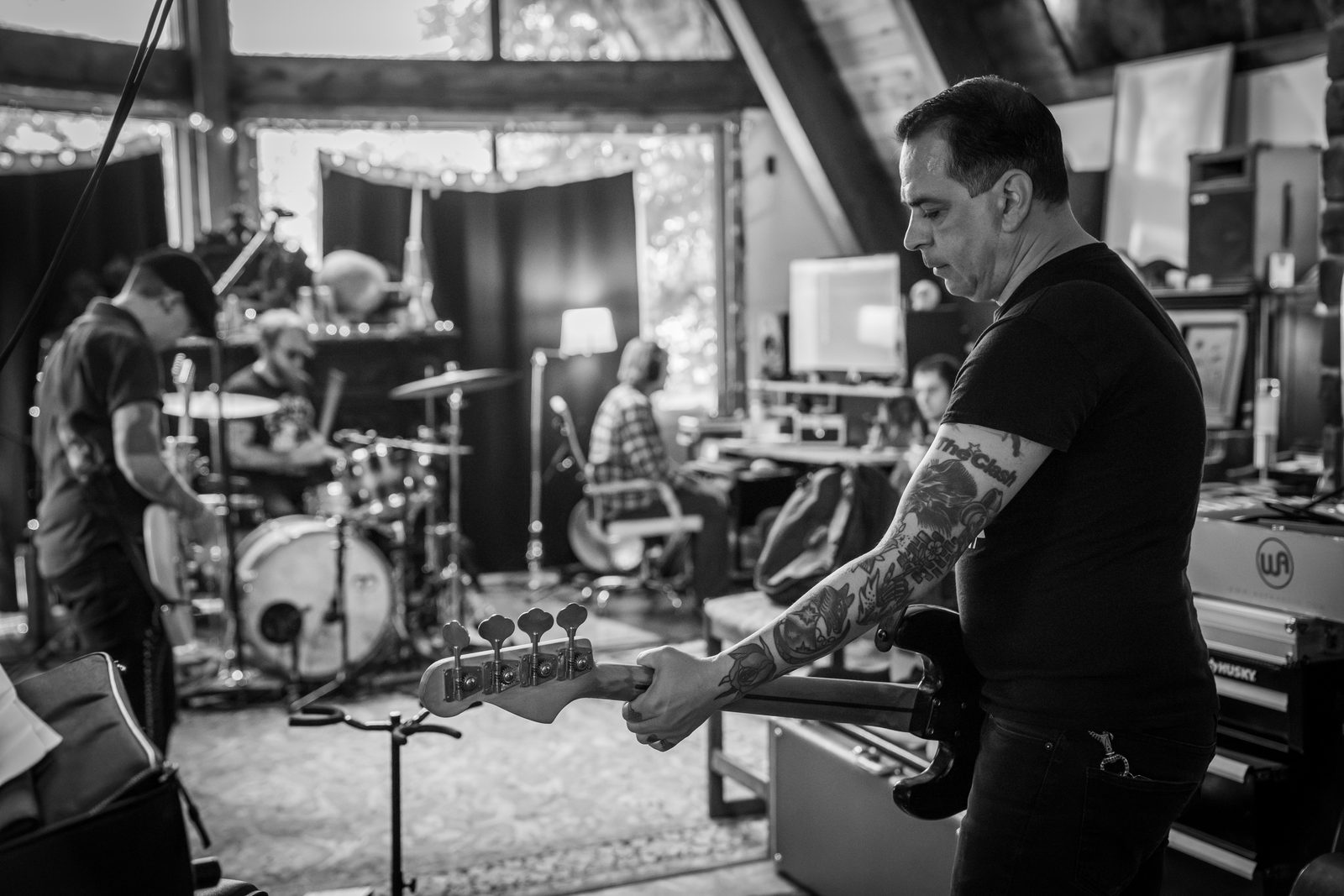 Tragic Lovers in the studio: bass player in the foreground, guitar and drums soft-focus behind.