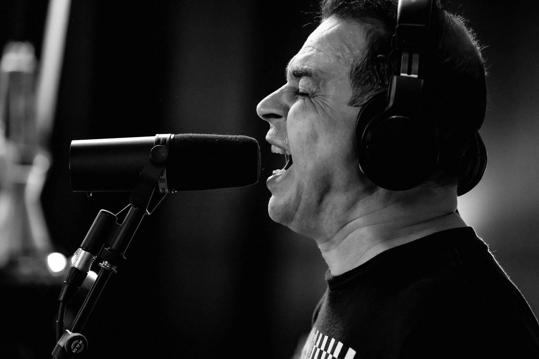 Tragic Lovers' singer recording vocals in the studio.